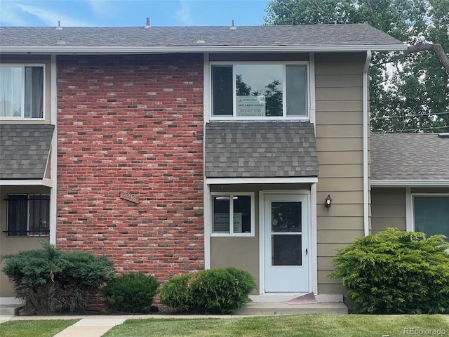 2218 Coronado Pkwy N Unit B, Denver, CO 80229 - view of front facade featuring roof with shingles
