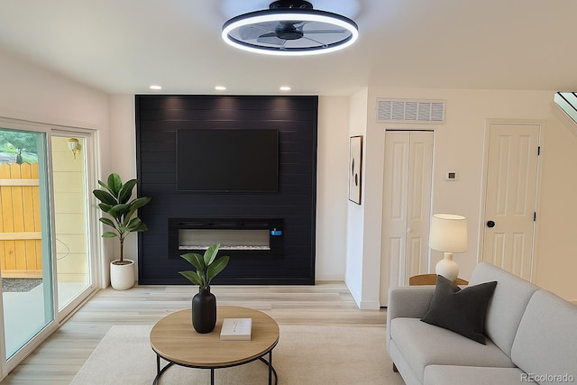 2218 Coronado Pkwy N Unit B, Denver, CO 80229 - living room featuring light wood-style flooring, a large fireplace, and recessed lighting