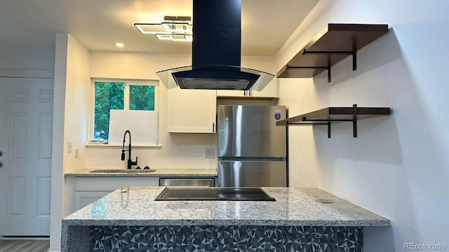 2218 Coronado Pkwy N Unit B, Denver, CO 80229 - kitchen with appliances with stainless steel finishes, ventilation hood, white cabinets, light stone counters, and recessed lighting