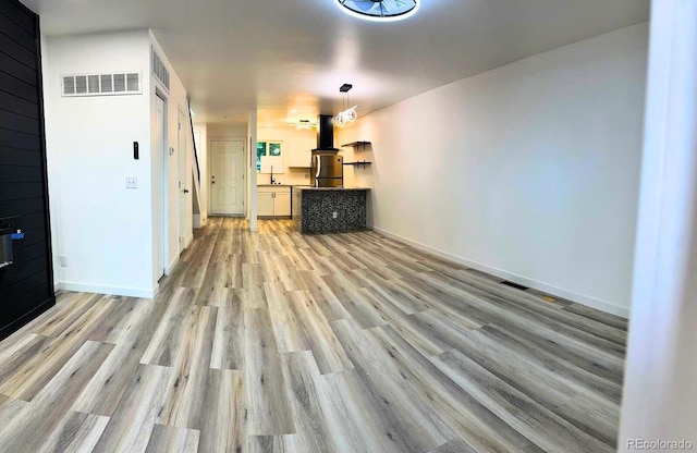 2218 Coronado Pkwy N Unit B, Denver, CO 80229 - unfurnished living room featuring light wood finished floors and baseboards