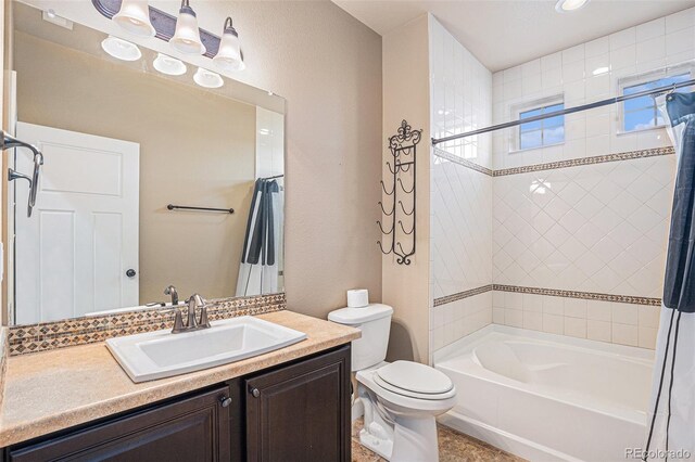 5521 Ensenada St, Denver, CO 80249 - full bathroom with toilet, vanity, and shower / tub combo