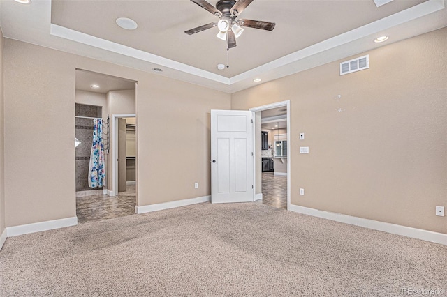 5521 Ensenada St, Denver, CO 80249 - unfurnished bedroom featuring recessed lighting, carpet, baseboards, a walk in closet, and a tray ceiling