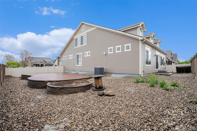5521 Ensenada St, Denver, CO 80249 - view of side of property with a fenced backyard, central AC, and a patio area