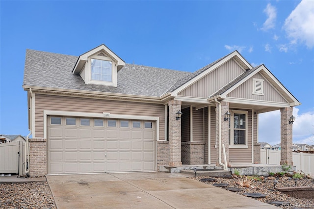 5521 Ensenada St, Denver, CO 80249 - view of front of property featuring a porch, brick siding, concrete driveway, a shingled roof, and a garage