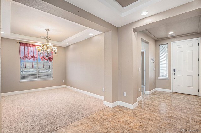 5521 Ensenada St, Denver, CO 80249 - carpeted foyer entrance featuring a raised ceiling, healthy amount of natural light, recessed lighting, a chandelier, and baseboards