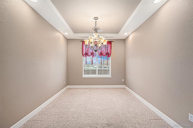 5521 Ensenada St, Denver, CO 80249 - unfurnished room with a chandelier, light colored carpet, baseboards, a raised ceiling, and recessed lighting