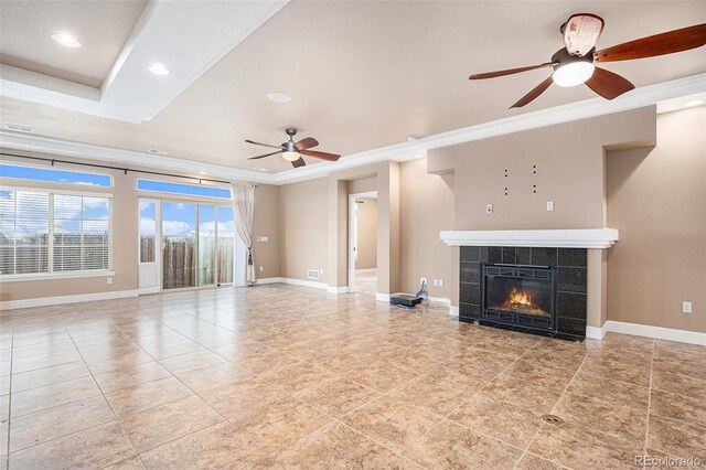 5521 Ensenada St, Denver, CO 80249 - unfurnished living room with a ceiling fan, ornamental molding, a tiled fireplace, baseboards, and recessed lighting
