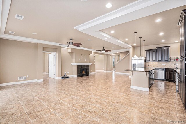 5521 Ensenada St, Denver, CO 80249 - kitchen with open floor plan, stainless steel appliances, recessed lighting, ceiling fan, and light tile patterned flooring