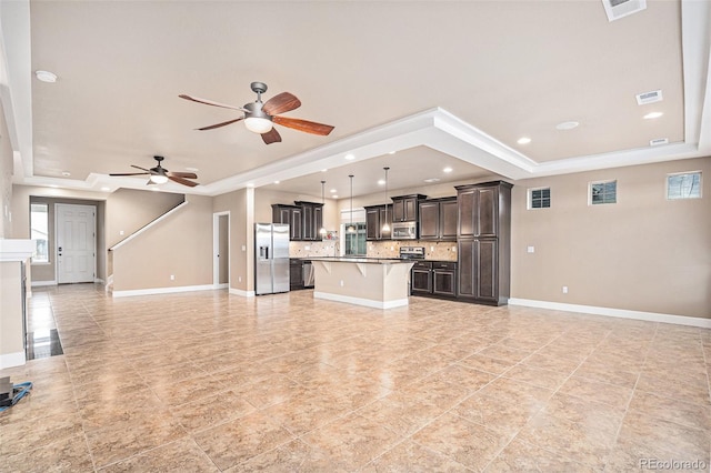 5521 Ensenada St, Denver, CO 80249 - unfurnished living room with a tray ceiling, ceiling fan, baseboards, recessed lighting, and ornamental molding