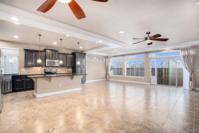 5521 Ensenada St, Denver, CO 80249 - kitchen featuring appliances with stainless steel finishes, a ceiling fan, open floor plan, a kitchen bar, and recessed lighting