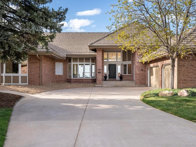 43 Falcon Hills Dr, Highlands Ranch, CO 80126 - exterior space featuring brick siding, an attached garage, driveway, and a tile roof