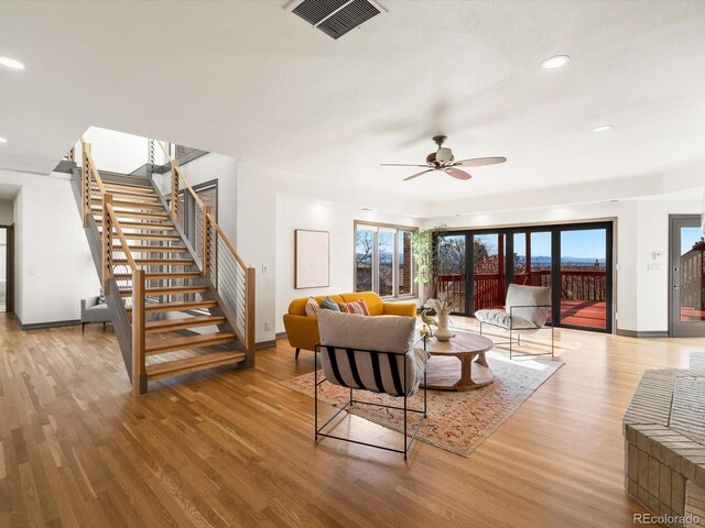 43 Falcon Hills Dr, Highlands Ranch, CO 80126 - living area featuring baseboards, visible vents, wood finished floors, and stairway