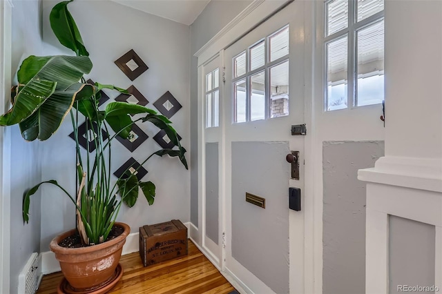 3259 Lowell Blvd, Denver, CO 80211 - doorway with plenty of natural light, wood finished floors, and a baseboard heating unit