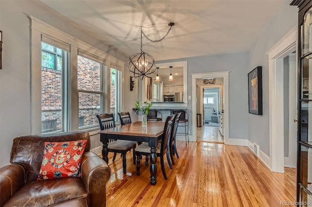 3259 Lowell Blvd, Denver, CO 80211 - dining space with a chandelier and light wood-style flooring