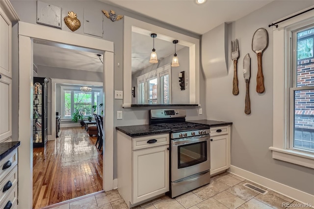 3259 Lowell Blvd, Denver, CO 80211 - kitchen featuring stainless steel range with gas cooktop, decorative light fixtures, recessed lighting, and dark stone countertops