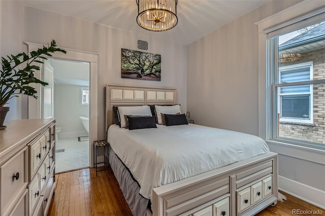3259 Lowell Blvd, Denver, CO 80211 - bedroom with a chandelier and hardwood / wood-style floors