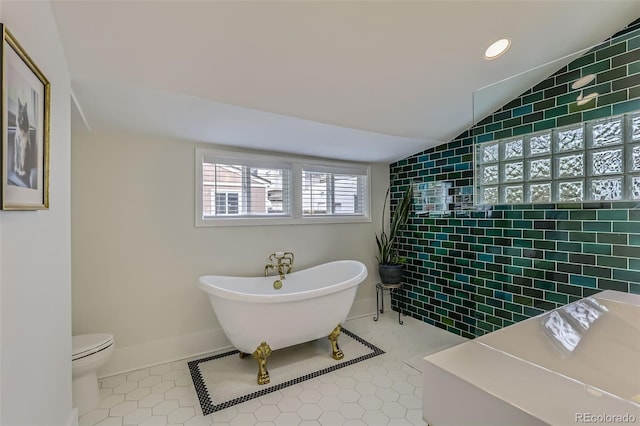 3259 Lowell Blvd, Denver, CO 80211 - bathroom featuring a freestanding tub, tile patterned floors, a tile shower, vaulted ceiling, and recessed lighting