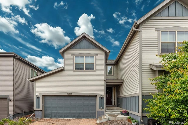 9723 Bennett Peak St, Littleton, CO 80125 - view of front facade with decorative driveway, board and batten siding, and a garage