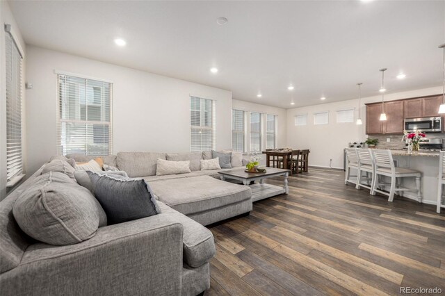 9723 Bennett Peak St, Littleton, CO 80125 - living room featuring dark wood finished floors, recessed lighting, and baseboards