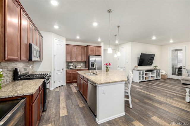 9723 Bennett Peak St, Littleton, CO 80125 - kitchen with stainless steel appliances, a sink, dark wood-style flooring, decorative backsplash, and a kitchen bar