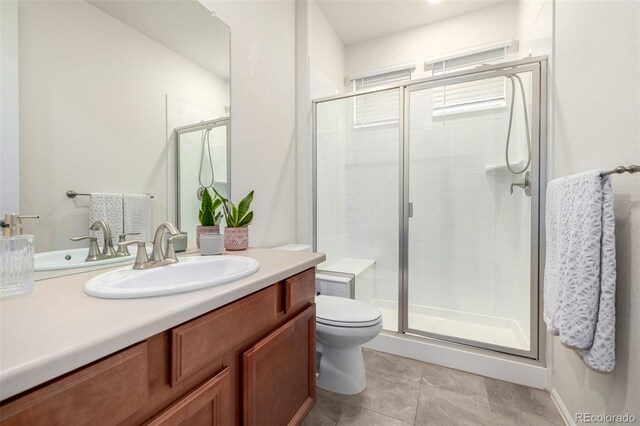 9723 Bennett Peak St, Littleton, CO 80125 - full bath with vanity, toilet, a stall shower, and tile patterned flooring