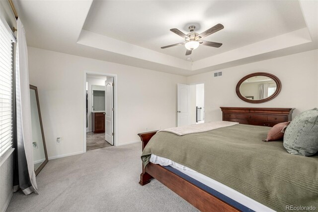 9723 Bennett Peak St, Littleton, CO 80125 - bedroom with a tray ceiling, light colored carpet, baseboards, and multiple windows