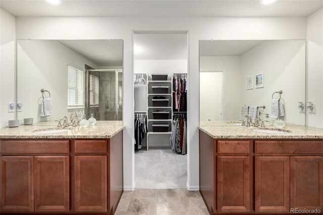 9723 Bennett Peak St, Littleton, CO 80125 - full bathroom with a shower stall, a walk in closet, and two vanities