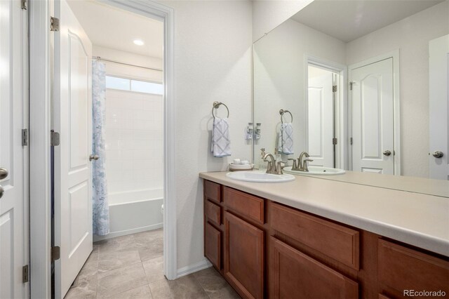 9723 Bennett Peak St, Littleton, CO 80125 - full bathroom with vanity, shower / bath combination with curtain, baseboards, and tile patterned floors