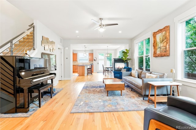 4414 Wolff St, Denver, CO 80212 - living area featuring light wood finished floors, ceiling fan, stairs, and recessed lighting