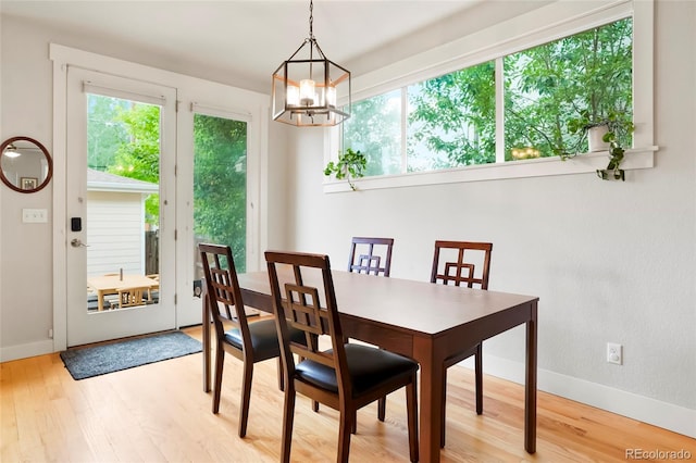 4414 Wolff St, Denver, CO 80212 - dining space with healthy amount of natural light, a chandelier, and wood finished floors