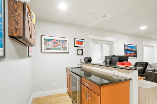 4414 Wolff St, Denver, CO 80212 - kitchen with beverage cooler, open floor plan, dark stone counters, brown cabinets, and a peninsula