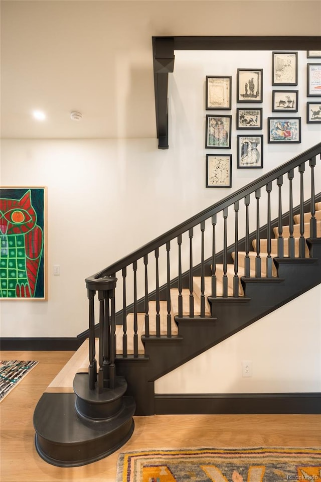 stairs with baseboards, recessed lighting, and wood finished floors