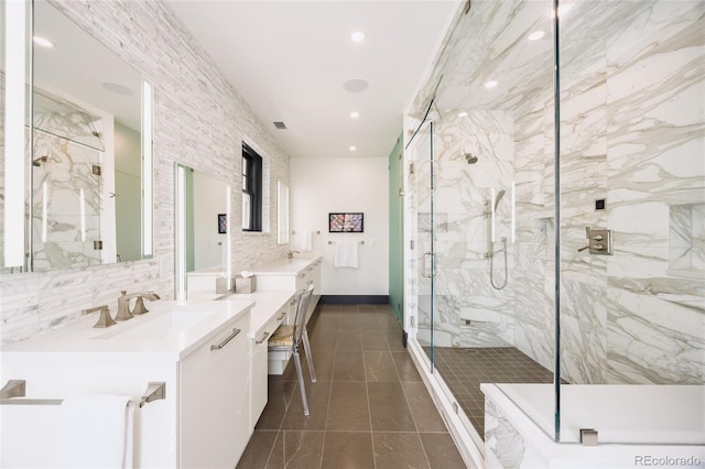 full bath featuring vanity, recessed lighting, a marble finish shower, and tile patterned floors