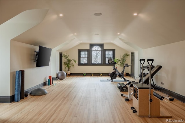 exercise area with recessed lighting, baseboards, vaulted ceiling, and light wood finished floors