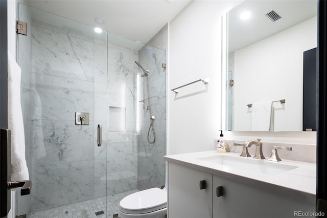 bathroom with visible vents, a marble finish shower, toilet, and vanity