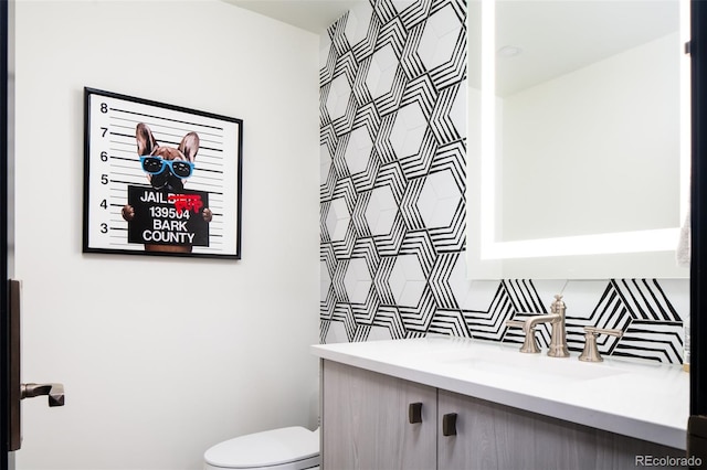 bathroom featuring vanity and toilet