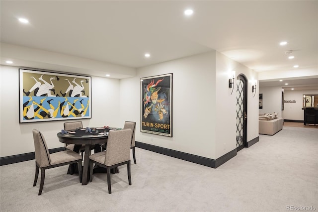 dining space with baseboards, light carpet, and recessed lighting