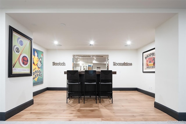 interior space with baseboards, recessed lighting, and light wood-style floors