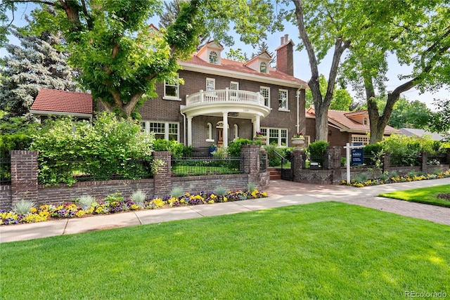 3309 E 7th Avenue Pkwy, Denver, CO 80206 - colonial house featuring a front lawn, brick siding, and a balcony