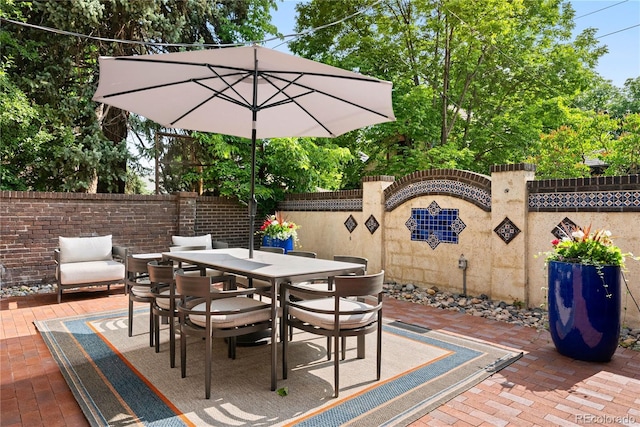 3309 E 7th Avenue Pkwy, Denver, CO 80206 - fenced backyard with a patio, outdoor dining area, and view of scattered trees
