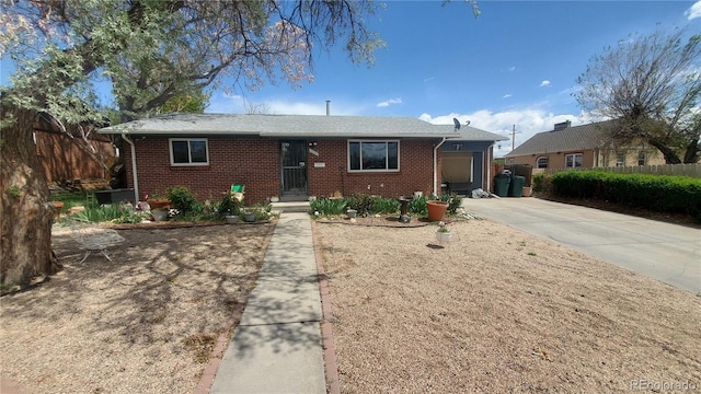 single story home with fence, concrete driveway, and brick siding