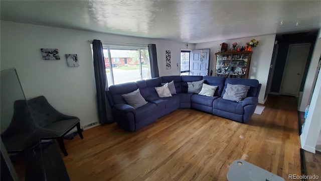 living room featuring visible vents and light wood-type flooring