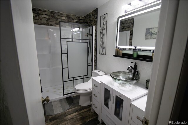 7620 Hooker St, Westminster, CO 80030 - full bath with a shower stall, toilet, wood finished floors, and vanity