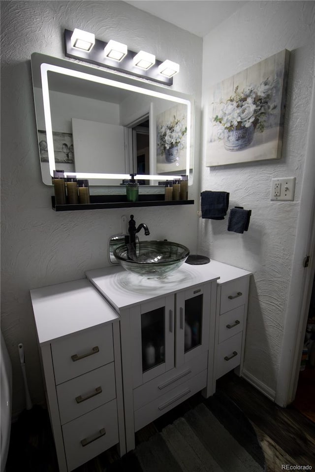 7620 Hooker St, Westminster, CO 80030 - bathroom featuring vanity, wood finished floors, and a textured wall