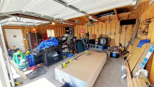 7620 Hooker St, Westminster, CO 80030 - garage with freestanding refrigerator and a garage door opener