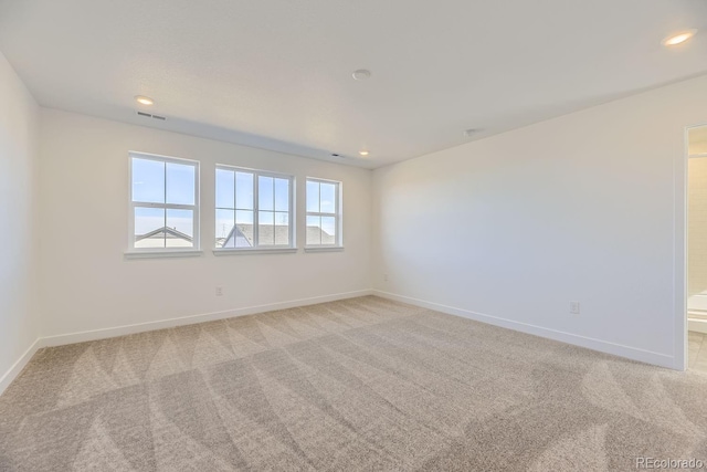 unfurnished room featuring recessed lighting, visible vents, baseboards, and light colored carpet