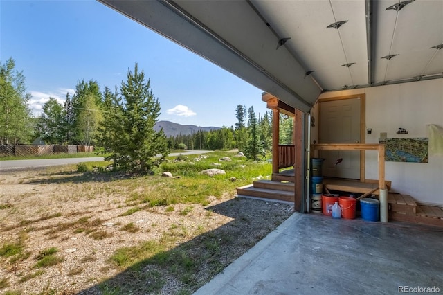 view of yard featuring a mountain view and a patio