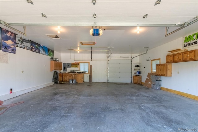 garage with electric panel and a garage door opener