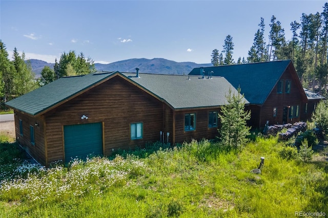 view of front of home with a mountain view and a garage