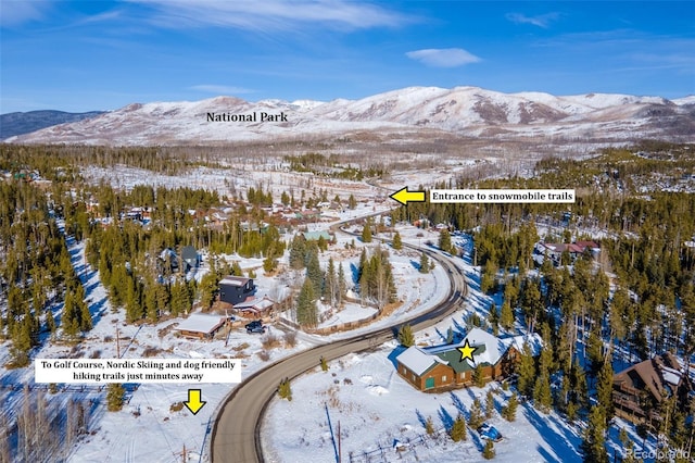 snowy aerial view featuring a mountain view